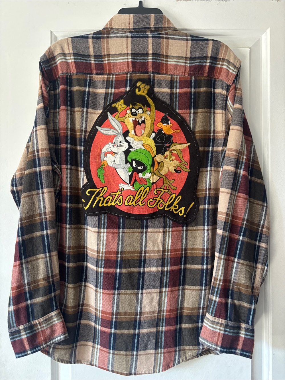 Upcycled flannel with Looney Tunes logo.
